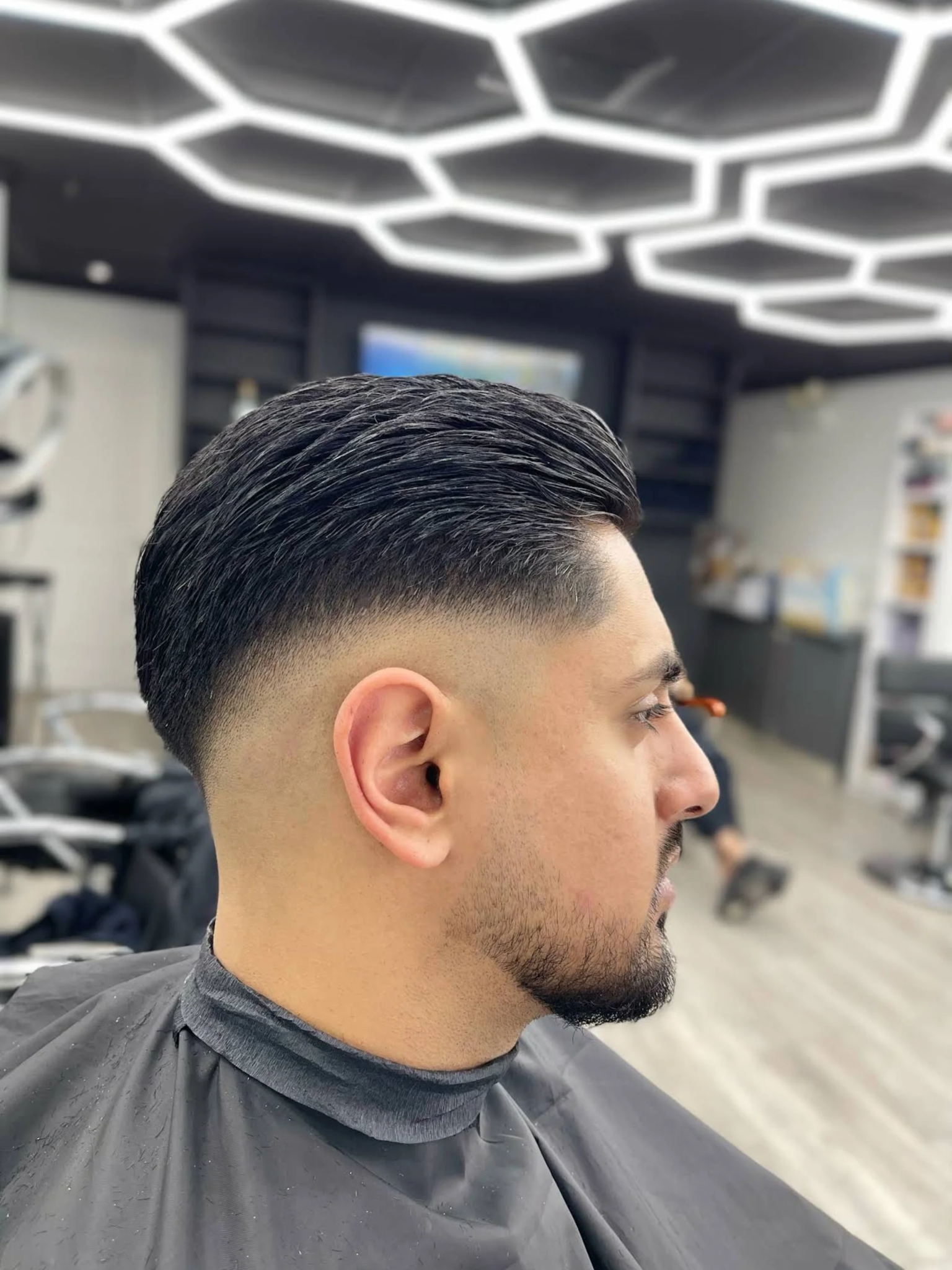Customer with a fresh skin fade haircut at Dapper Barber Lounge in Vancouver.